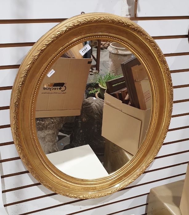 Oval mirror in moulded gilt effect frame, 70cm x 60cm