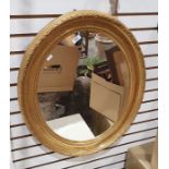 Oval mirror in moulded gilt effect frame, 70cm x 60cm