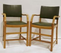 Two utility-type oak-framed carver chairs with vinyl seats and backs (2)