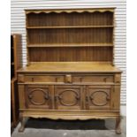 20th century oak dresser, shelves above a base with two drawers and three cupboard doors on claw and