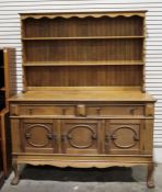 20th century oak dresser, shelves above a base with two drawers and three cupboard doors on claw and