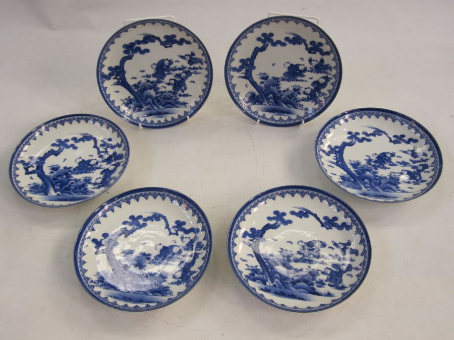 Set of six Japanese Hirado-type porcelain saucer dishes, each painted in underglaze blue with boys