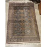 Eastern grey ground rug with two rows of six hooked diamond motifs and multiple geometric borders,