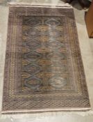 Eastern grey ground rug with two rows of six hooked diamond motifs and multiple geometric borders,