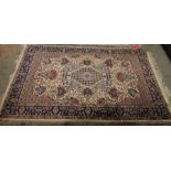 Persian style ivory rug with central lozenge medallions surrounded by floral and stylised animal