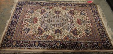 Persian style ivory rug with central lozenge medallions surrounded by floral and stylised animal