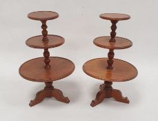 Pair of miniature wooden dumbwaiters, each having three circular graduated tiers and on tripod base,