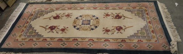 Chinese ivory ground rug with large central medallion and floral decoration with multiple floral