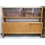 Mid-century modern teak lounge unit by Skovby, the top with sliding glass doors enclosing shelves on
