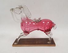 Cranberry and clear glass model of a horse, late 19th/early 20th century, on wooden stand, with