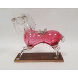 Cranberry and clear glass model of a horse, late 19th/early 20th century, on wooden stand, with