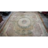 Large Aubusson style cream ground carpet with central floral motif surrounded by floral decoration