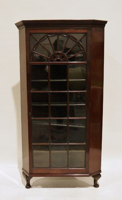 Late 19th/early 20th century mahogany corner display cabinet with astragal-glazed door, raised on