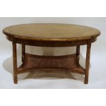 Modern oak oval coffee table with rounded top, moulded edge, moulded supports, caned and shaped