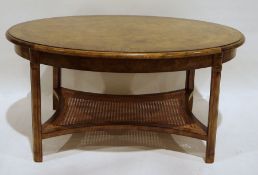 Modern oak oval coffee table with rounded top, moulded edge, moulded supports, caned and shaped