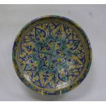 Moroccan pottery charger, late 19th/early 20th century, painted in turquoise, blue and yellow with