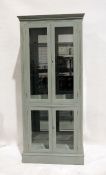 20th century painted display cabinet, moulded cornice above two glazed doors enclosing glass shelves