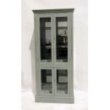 20th century painted display cabinet, moulded cornice above two glazed doors enclosing glass shelves