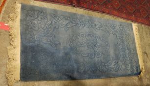 Chinese blue ground rug with floral pattern, 160cm x 69cm