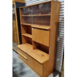 Mid-century modern teak lounge unit the top section with two sliding glass doors enclosing shelves
