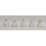 Five Lladro dated commemorative bells,  each tied with a little pink ribbon in white biscuit,