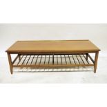 Mid century modern teak rectangular coffee table with magazine rack under, on shaped supports, 124cm