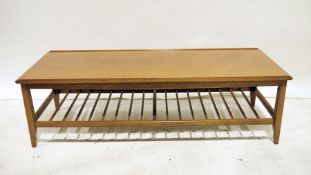 Mid century modern teak rectangular coffee table with magazine rack under, on shaped supports, 124cm