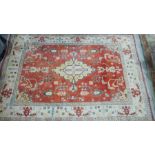 Turkish orange ground carpet with large central floral medallion surrounded by floral decoration,