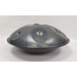 A steel handpan drum by Leigh Tolson of Stroud, tuned in the key of D minor, circular and elliptical