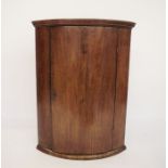19th century mahogany bowfront wall-hanging corner cabinet with ogee moulded cornice above the
