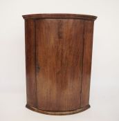 19th century mahogany bowfront wall-hanging corner cabinet with ogee moulded cornice above the