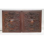 Pair of mahogany, heavily carved, wall hangings, each 52cm x 59cm (2)