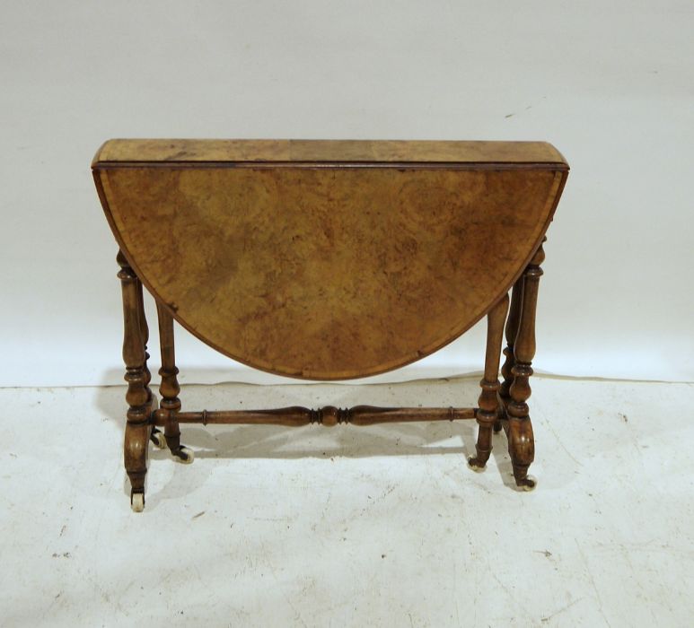 Early Victorian burr walnut gateleg table, the cross-banded top on baluster turned end supports,