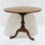 Georgian mahogany circular tripod table, the circular top on birdcage to turned pedestal and three