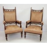 Pair of late Victorian oak-framed armchairs with upholstered seats, arms and backs, on turned