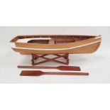 Wooden model rowing boat with oars, the boat 71cm long, on wooden stand
