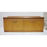 Mid century modern teak sideboard with two drawers above two bi-fold cupboard doors, on plinth base,