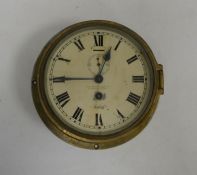 Henry Browne and Son Ltd brass case ship style clock with circular dial with Roman numerals, an