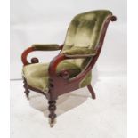 Late Victorian armchair with overscrolled arms, on turned front legs to brass castors, green