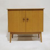 Mid century modern Meredew oak cupboard, the rectangular top above two doors enclosing shelves and