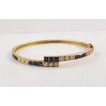 18ct gold, sapphire and diamond bangle, fine crossover pattern and set with 14 square-cut