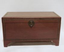 20th century Chinese camphorwood lined chest with foliate carved decoration and raised on bracket