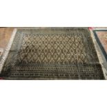 Eastern cream ground rug with stepped lozenge, floral border flanked by multiple geometric guard