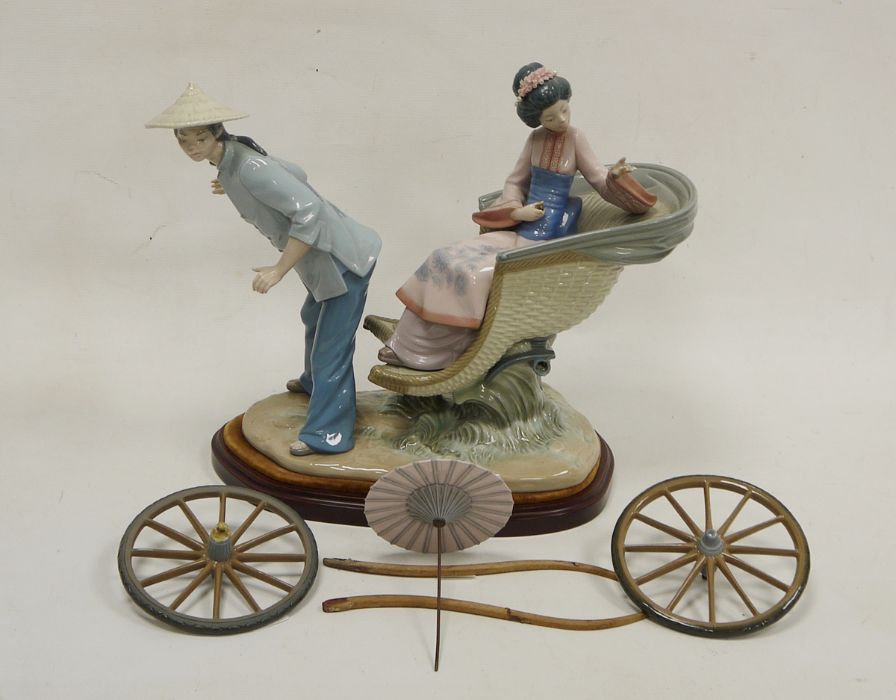 Lladro group of a Chinese girl in carriage, printed marks, the girl seated in a basket moulded