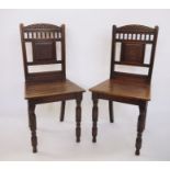 Pair of 19th century James Shoolbred mahogany hall chairs with carved shaped top rails above