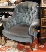 Late 19th/early 20th century low armchair in blue buttonback upholstery, on square section