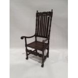 20th century armchair with carved top rail above slatted back, carved arm rests, turned, carved