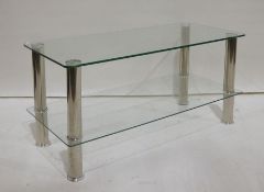 Two-tier glass television stand with chrome-effect supports