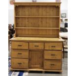Pine dresser with moulded cornice, two shelves, the base of seven drawers and kennel cupboard