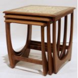 Mid century modern teak-framed nest of three coffee tables, the largest with tile top